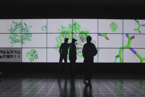 three silhouettes against illuminated panels displaying molecules