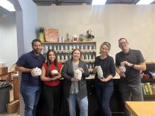 people displaying pottery pieces in studio