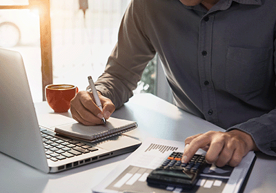 man doing financial calculations at a desk