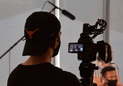 student filming sports interview