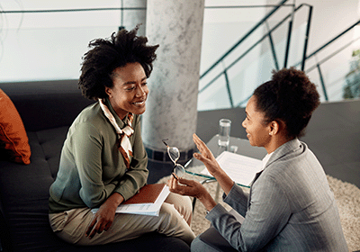 mentor talking happily with mentee