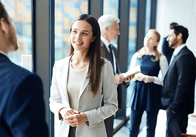 Professional smiling and listening to another professional speak