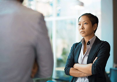 two people staring at each other with crossed arms