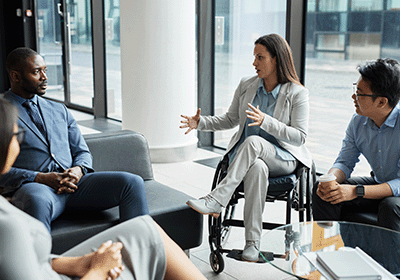 Professionals sit in group discussion