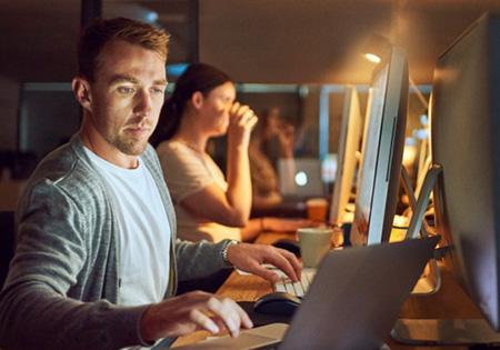 analyst working at two computers