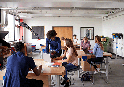 teacher mentoring student in science lab 