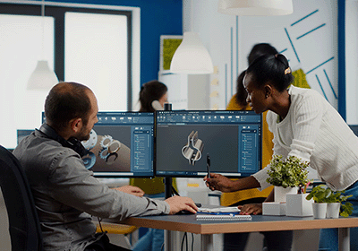 engineers review mechanical design on monitor