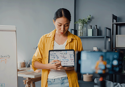 teacher using tablet to broadcast lesson on camera