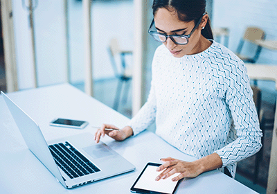 person working with multiple screens