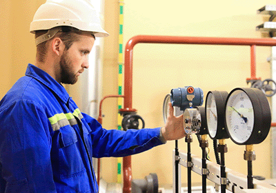 technician reading pressure gauge