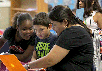 Teacher hands-on instruction with elementary students