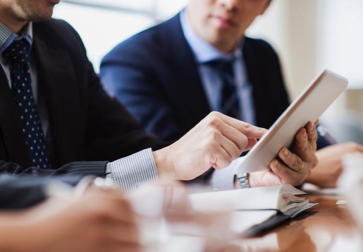 professional analyzing data on a tablet