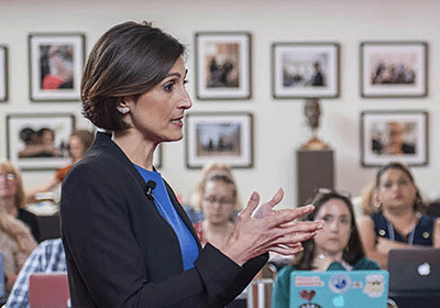 Woman speaks confidently to classroom of attentive women