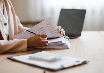 person reviewing stack of documents