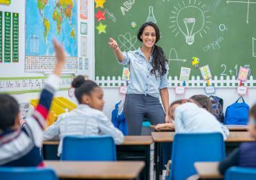 teacher calling on eager student who is raising their hand