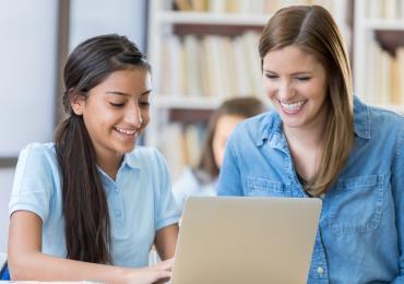 teacher providing one-on-one instruction to student