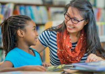 teacher working with young student one-on-one