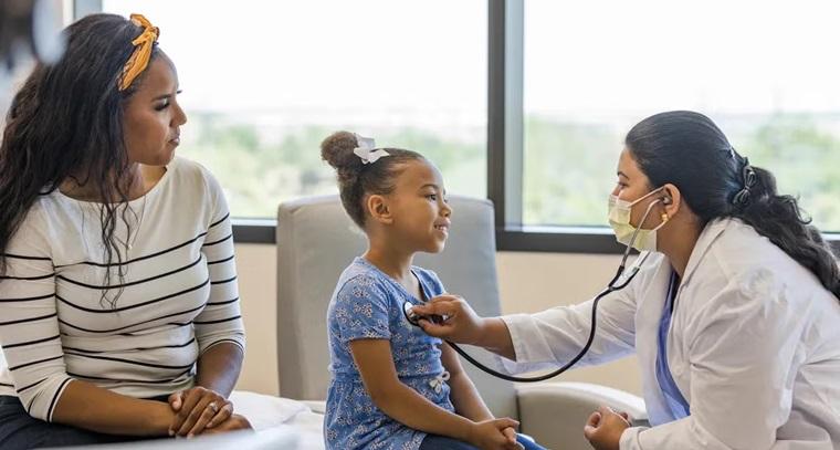 Pediatric Physician listening to child patient heartbeat with stethoscop