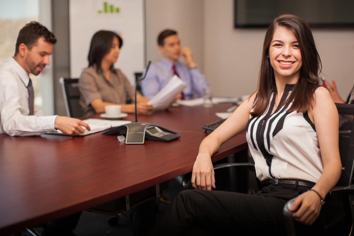 business professional in conference room with colleagues