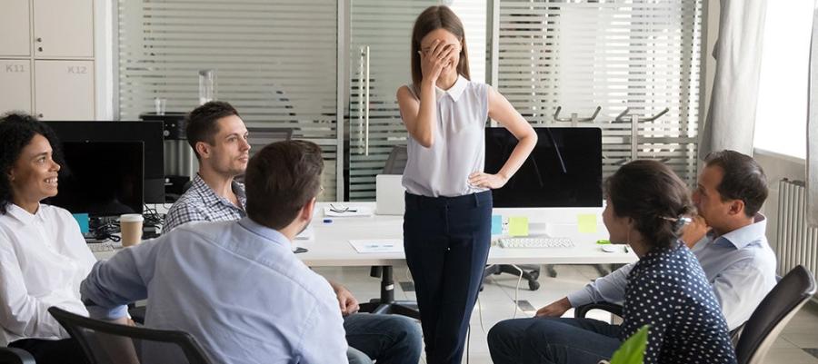 Professional covering face embarrassed in front of colleagues